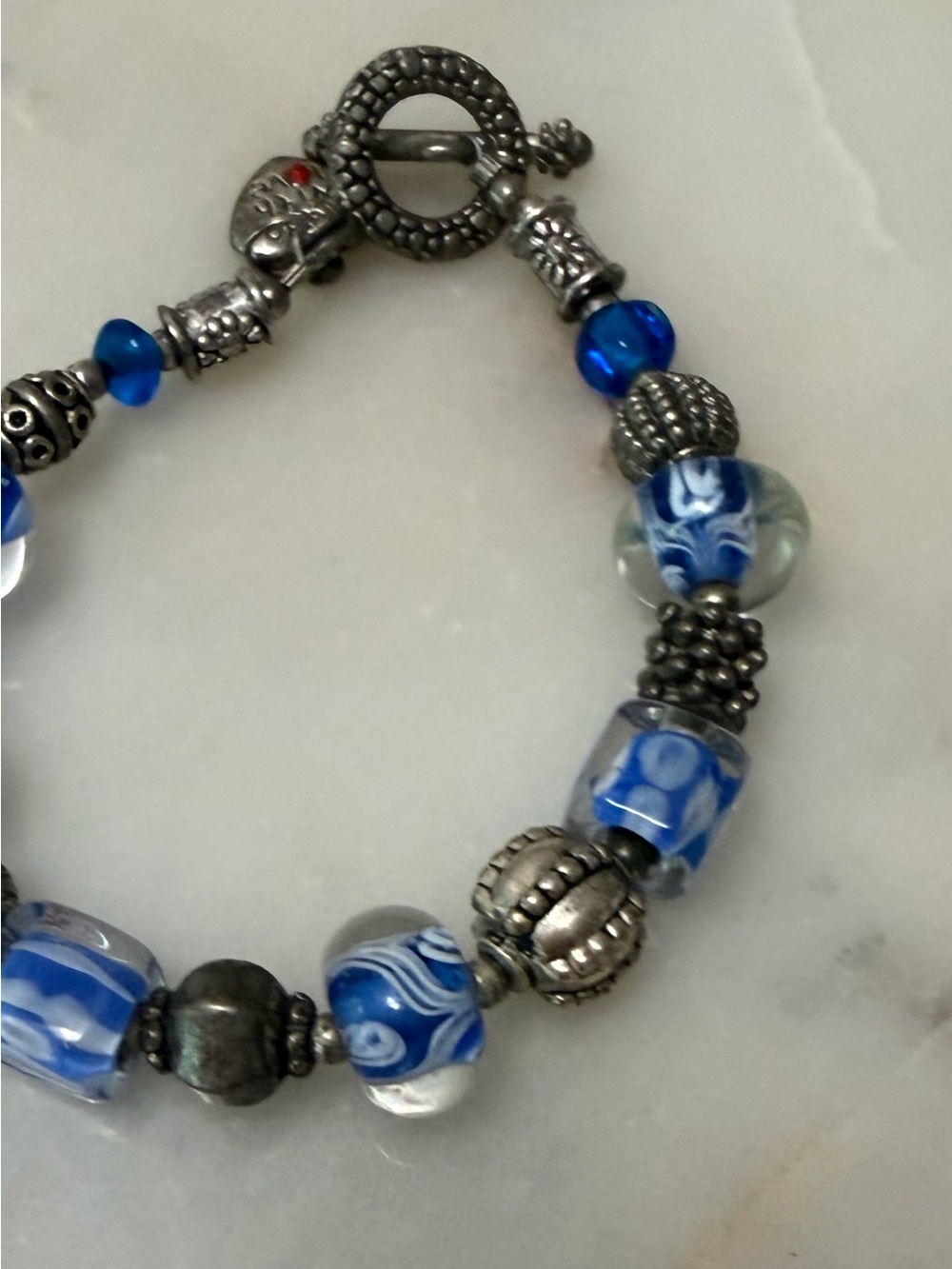 European style charm bracelet with blue glass beads